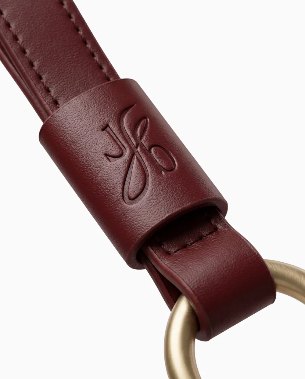 Visualisation: close up of the leather keeper with the Jb blind debossed above a brass O ring
